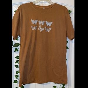 Brown t-shirt with light blue butterflies.